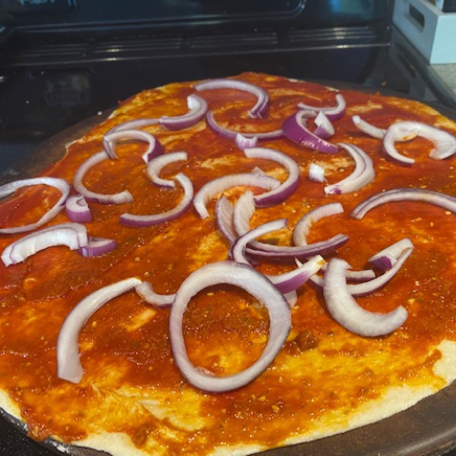 Onions are sliced for homemade pizza